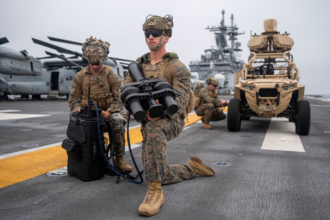 U.S. Marine Corps Sgt. Wesley Mechatto, left, a squad leader and native of California, and Cpl. Nikolaus Tinsley, a machine gunner and native of California, both assigned to Battalion Landing Team 1/5, 15th Marine Expeditionary Unit, prepare to employ a NightFighter S portable counter-unmanned aerial vehicle system during training aboard the amphibious assault ship USS Boxer (LHD 4) in the Pacific Ocean July 6, 2024. Elements of the 15th MEU are currently embarked aboard the Boxer Amphibious Ready Group conducting routine operations in U.S. 3rd Fleet. (U.S. Marine Corps photo by Cpl. Amelia Kang)