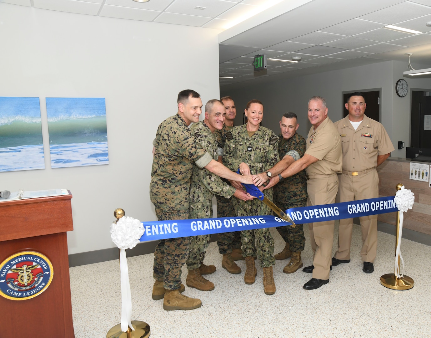 Leadership with Naval Medical Forces Atlantic, Defense Health Agency, Naval Medical Center Camp Lejeune, 2nd Marine Aircraft Wing, Marine Corps Installations East, and Marine Air Station New River help cut the ceremonial ribbon during the grand opening ceremony of the Marine Centered Medical Home (MCMH) New River clinic aboard Marine Corps Air Station New River on July 26, 2024. MCMH New River provides routine appointments/physicals and some specialty services to active duty personnel aboard Marine Corps Air Station New River.