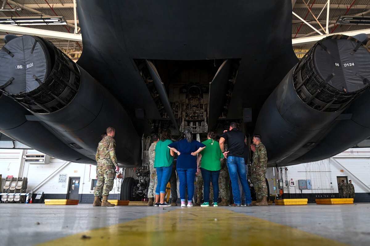 Honorary commanders from Goodfellow Air Force Base, receive a tour of a B-1B Lancer at Dyess Air Force Base, Texas, July 24, 2024. The honorary commanders took part in an hour-long flight, visited the air traffic control tower, engaged in virtual reality training and toured the B-1B Lancer, known for its ability to rapidly deliver massive quantities of precision and non-precision weapons against any adversary, anywhere in the world. (U.S. Air Force photo by Airman 1st Class Madison Collier)