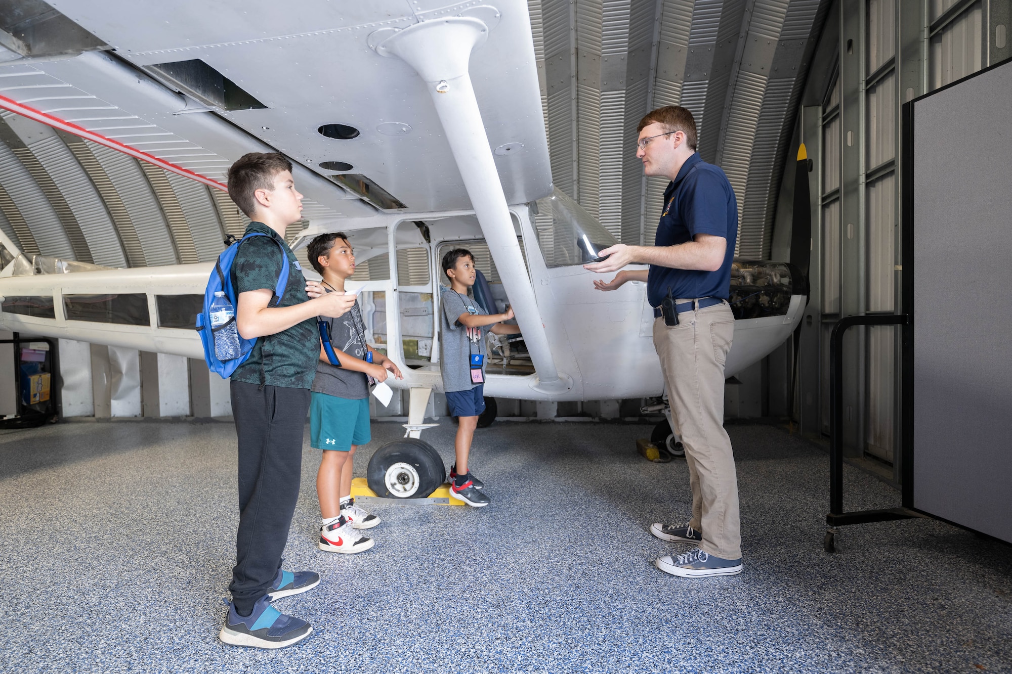 Nick McCloskey, Air Mobility Command Museum volunteer, speaks to youth about the various parts and components of an airplane during an Aviation Summer Camp at the AMC Museum on Dover Air Force Base, Delaware, July 23, 2024. During the week-long camp, the children were immersed in the history and science of aviation and participated in several hands-on activities under the supervision of AMC Museum volunteers. (U.S. Air Force photo by Mauricio Campino)