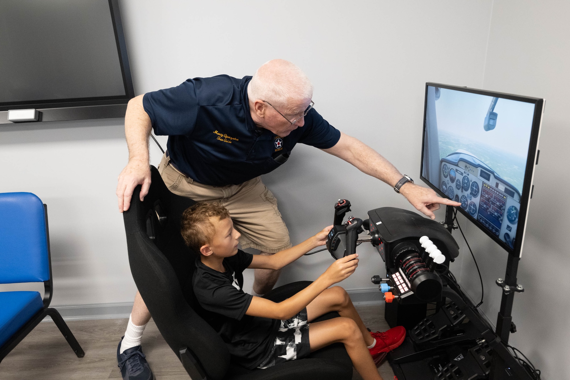 John Ogorzalek, Air Mobility Command Museum volunteer, instructs Jase Clark on how to land a plane using a flight simulator during Aviation Summer Camp at the AMC Museum on Dover Air Force Base, Delaware, July 23, 2024. The camp is designed for children ages 9-15, who are interested in aeronautics or a possible career in the U.S. Air Force. (U.S. Air Force photo by Mauricio Campino)