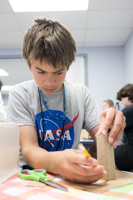 Everette Gray builds a diorama of a space habitat during Aviation Summer Camp at the Air Mobility Command Museum, on Dover Air Force Base, Delaware, July 24, 2024. During the week-long camp, the children were immersed in the history and science of aviation and participated in several hands-on activities under the supervision of AMC Museum volunteers. (U.S. Air Force photo by Mauricio Campino)