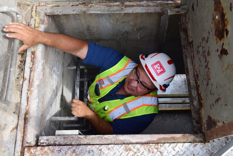 Michael Wilkinson, U.S. Army Corps of Engineers Nashville District’s Construction Support Section senior safety specialist, climbs out of a hatch July 22, 2024, at Wolf Creek Dam during a safety inspection with the contractor American Bridge Company, which is installing ladders as part of the spillway gates replacement project. Wilkinson works with contractors to promote safety, keeping workers safe and the project moving forward on time and within budget. (USACE Photo by Lee Roberts)