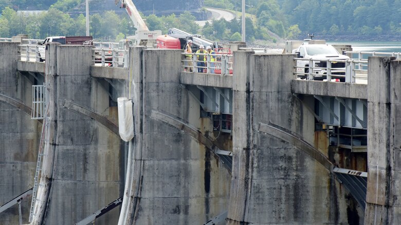 Michael Wilkinson (Right), U.S. Army Corps of Engineers Nashville District’s Construction Support Section senior safety specialist; and Mike Freeman (Left), construction inspector; speak with Eddie Mills, American Bridge Company quality manager, about safety during the installation of ladders July 22, 2024, on Wolf Creek Dam as part of the spillway gates replacement project. (USACE Photo by Lee Roberts)