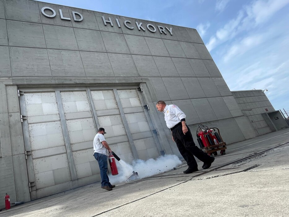 Old Hickory Powerhouse Maintenance Supervisor Chris Campbell extinguishes a fire during a training exercise Nov. 14, 2023, at Old Hickory Dam on the Cumberland River in Hendersonville, Tennessee. An Old Hickory Fire Department firefighter supervised the annual fire extinguisher training. (USACE Photo)