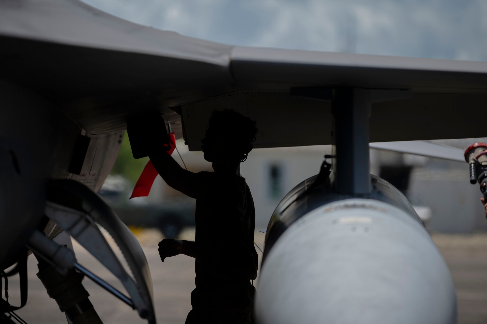 A U.S. Airman assigned to the 169th Aircraft Maintenance Squadron, South Carolina Air National Guard, prepares an F-16 Fighting Falcon fighter jet assigned to the 169th Fighter Wing to depart after a hot-pit refueling during exercise Caribbean Fox at Muñiz Air National Guard Base, Carolina, Puerto Rico, July 23, 2024. Caribbean Fox is designed to challenge participants in dynamic training scenarios during a two-week period along with offering tailored training for accomplishing critical Agile Combat Employment (ACE) readiness requirements. (U.S. Air National Guard photo by Airman 1st Class Victoria A. Jewett)