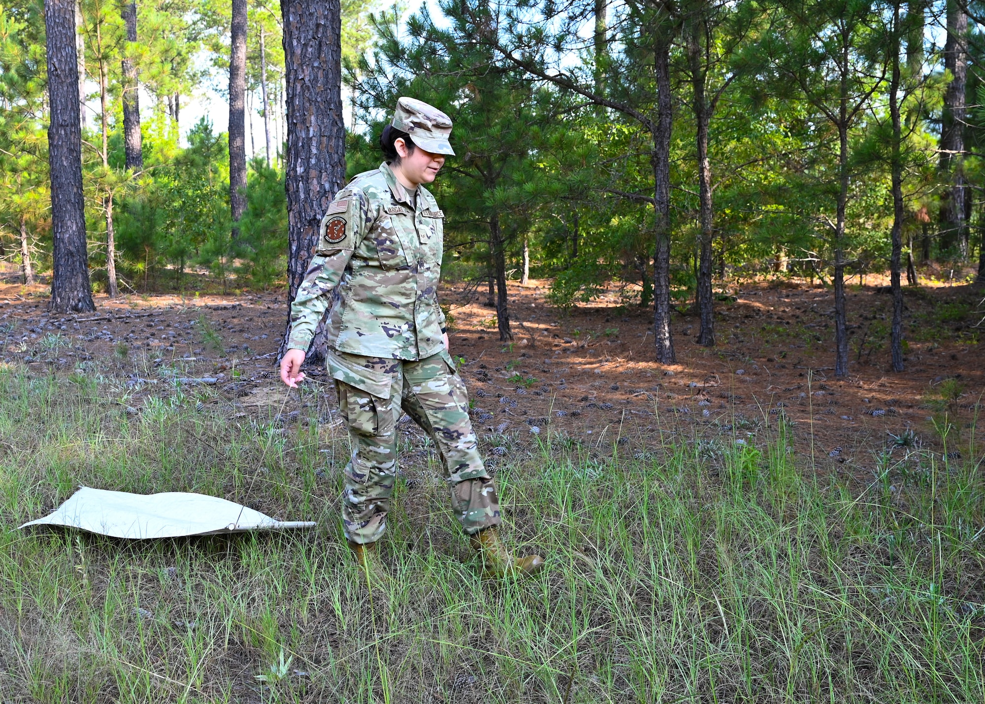 Airman drags rag on grass.