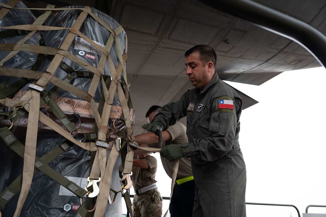 Team Dover Airmen and Chilean Airmen load cargo at Dover Air Force Base, Delaware, July 23, 2024. The visit was part of a multi-day Foreign Military Sales mission between the United States and Chile. Chile is one of the United States’ strongest partners in Latin America and a leader in promoting respect for the rule of law, economic stability, education, environmental protection, human rights, and sustainable development. (U.S. Air Force photo by Senior Airman Dieondiere Jefferies)