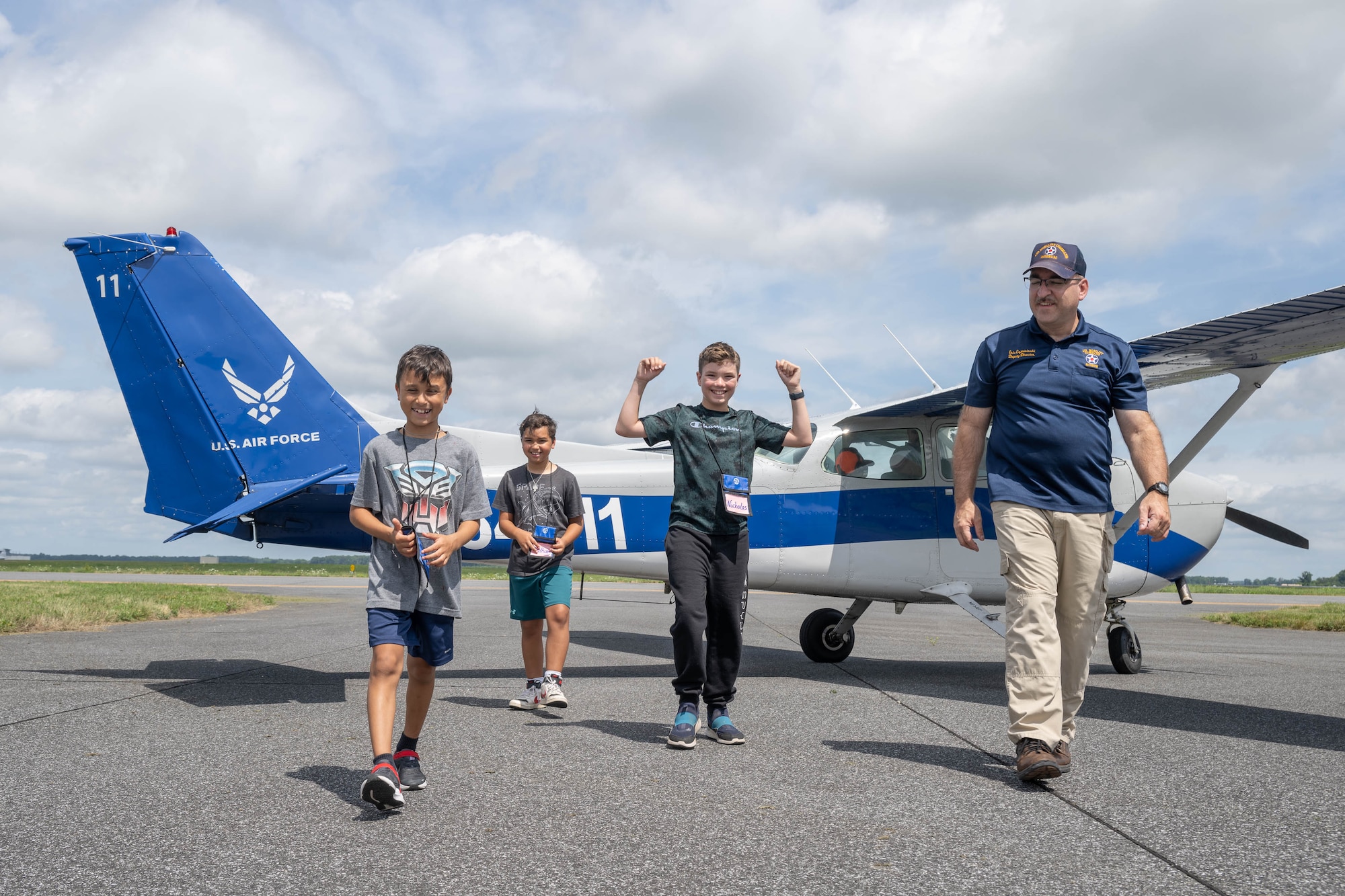 Eric Czerwinski, Air Mobility Command Museum deputy director, escorts youth off the flight line after completing a flight in a Cessna 172 during Aviation Summer Camp at the AMC Museum on Dover Air Force Base, Delaware, July 23, 2024. The camp is designed for children ages 9-15, who are interested in aeronautics or a possible career in the U.S. Air Force. (U.S. Air Force photo by Mauricio Campino)