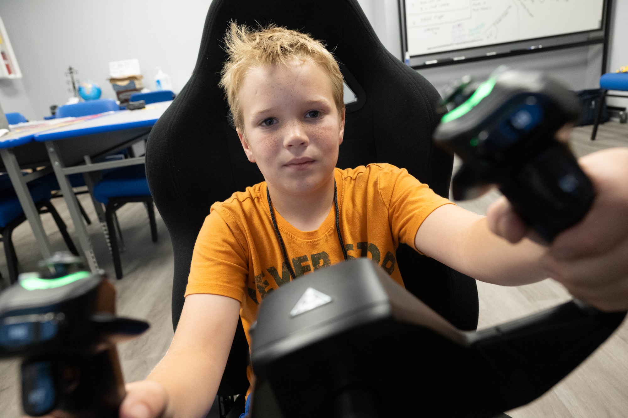 Matthew Longmire lands a plane using a flight simulator during Aviation Summer Camp at the Air Mobility Command Museum on Dover Air Force Base, Delaware, July 23, 2024. During the week-long camp, the children were immersed in the history and science of aviation and participated in several hands-on activities under the supervision of AMC Museum volunteers. (U.S. Air Force photo by Mauricio Campino)