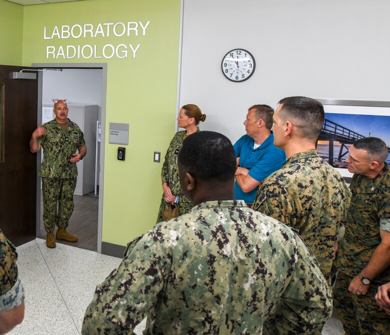 Leadership with Naval Medical Forces Atlantic, Defense Health Agency, Naval Medical Center Camp Lejeune, 2nd Marine Aircraft Wing, Marine Corps Installations East, and Marine Air Station New River tour the facility after the  grand opening ceremony of the Marine Centered Medical Home (MCMH) New River clinic aboard Marine Corps Air Station New River on July 26, 2024. MCMH New River provides routine appointments/physicals and specialty services to active-duty personnel aboard MCAS New River.