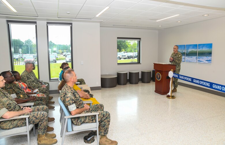 Rear Admiral Kevin Brown, Naval Medical Forces Atlantic commander, makes his guest speaker remarks during the grand opening ceremony of the Marine Centered Medical Home (MCMH) New River clinic aboard Marine Corps Air Station New River on July 26, 2024. MCMH New River provides routine appointments/physicals and some specialty services to active-duty personnel aboard MCAS New River.