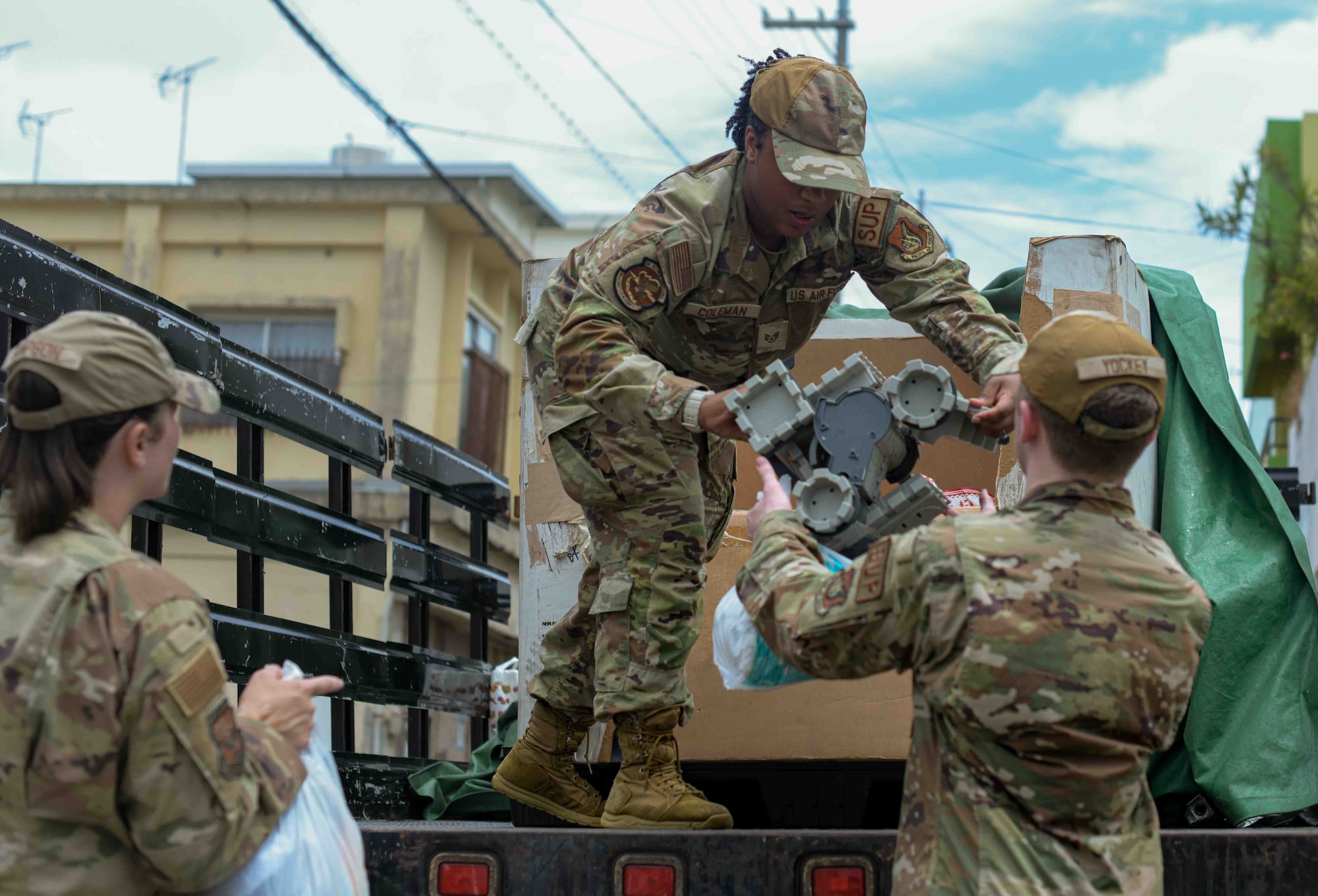 U.S. Air Force Staff Sgt. Tamilet Coleman, 18th Logistics Readiness Squadron, Airman 1st Class Kahle Yockey, 18th Logistics Readiness Squadron, and Tech. Sgt. Brittany Sampson, 353rd Special Operations Wing, during a Christmas in July event at a child support facility outside Kadena Air Base, Japan, July 23, 2024.