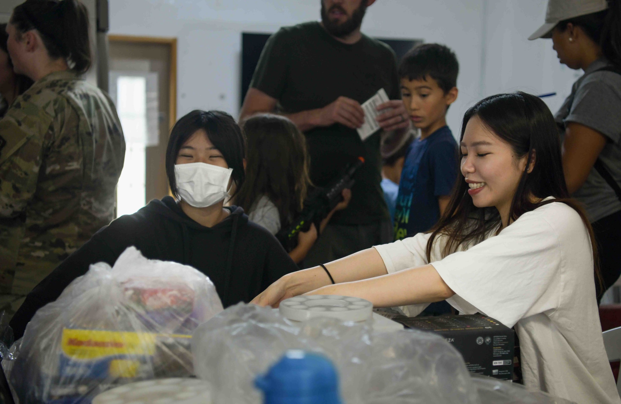 Children and child support facility staff members sort through donations during a Christmas in July event at a child support facility outside Kadena Air Base, Japan, July 23, 2024
