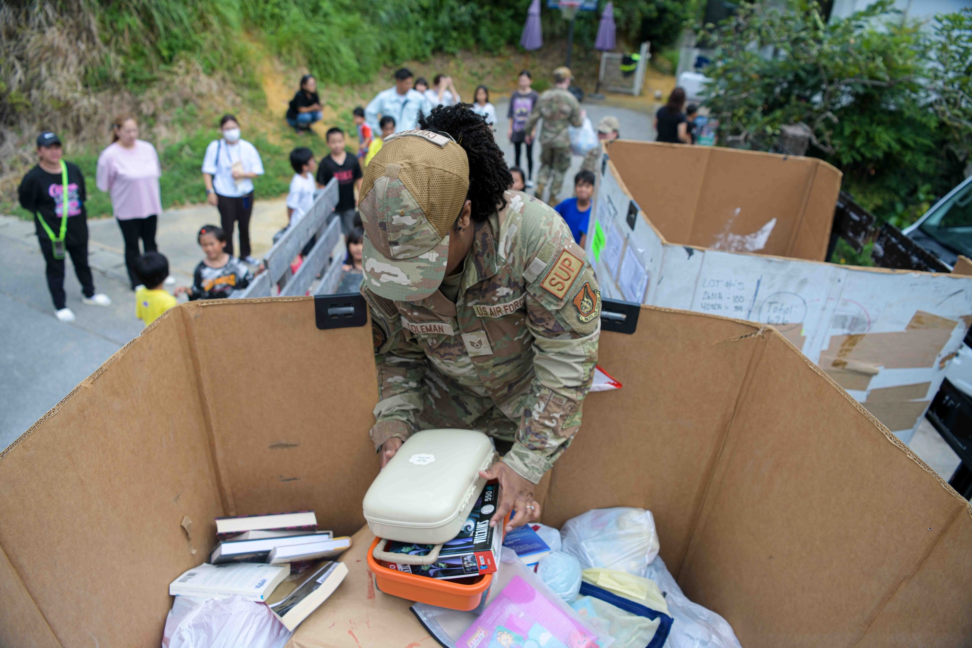 U.S Air Force Staff Sgt. Tamilet Coleman, 18th Logistics Readiness Squadron M-Flight resource and training advisor retrieves donated toys from a truck bed during a Christmas in July event at a child support facility outside Kadena Air Base, Japan, July 23, 2024.
