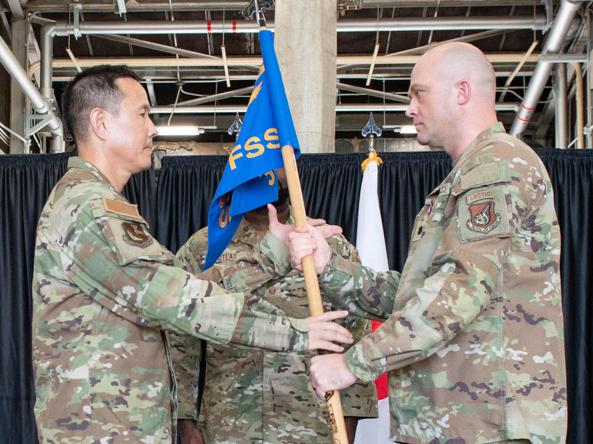 U.S. Air Force Col. Burt Okamoto, 374th Mission Support Group commander, left, receives the guidon.