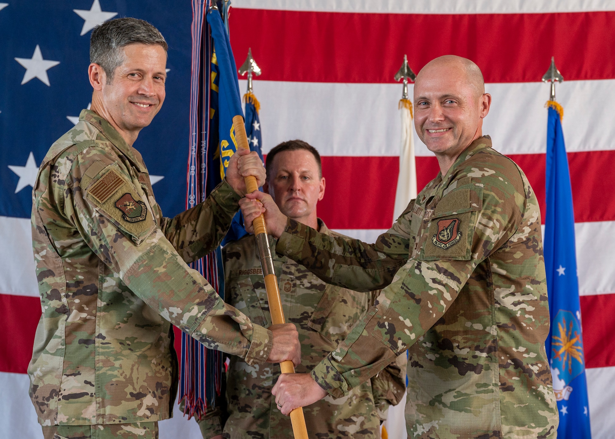 U.S. Air Force Col. Jeff Elliott, 51st Mission Support Group commander, right, accepts command of the 51st MSG from Col. William McKibban, 51st Fighter Wing commander, during a change of command ceremony at Osan Air Base, Republic of Korea, July 26, 2024. Elliott has deployed as the Combined Joint Special Operations Air Component executive officer to Al Udeid, Qatar, and as a Joint Task Force deputy to Guantanamo Bay, Cuba. (U.S. Air Force photo by Senior Airman Sabrina Fuller-Judd)
