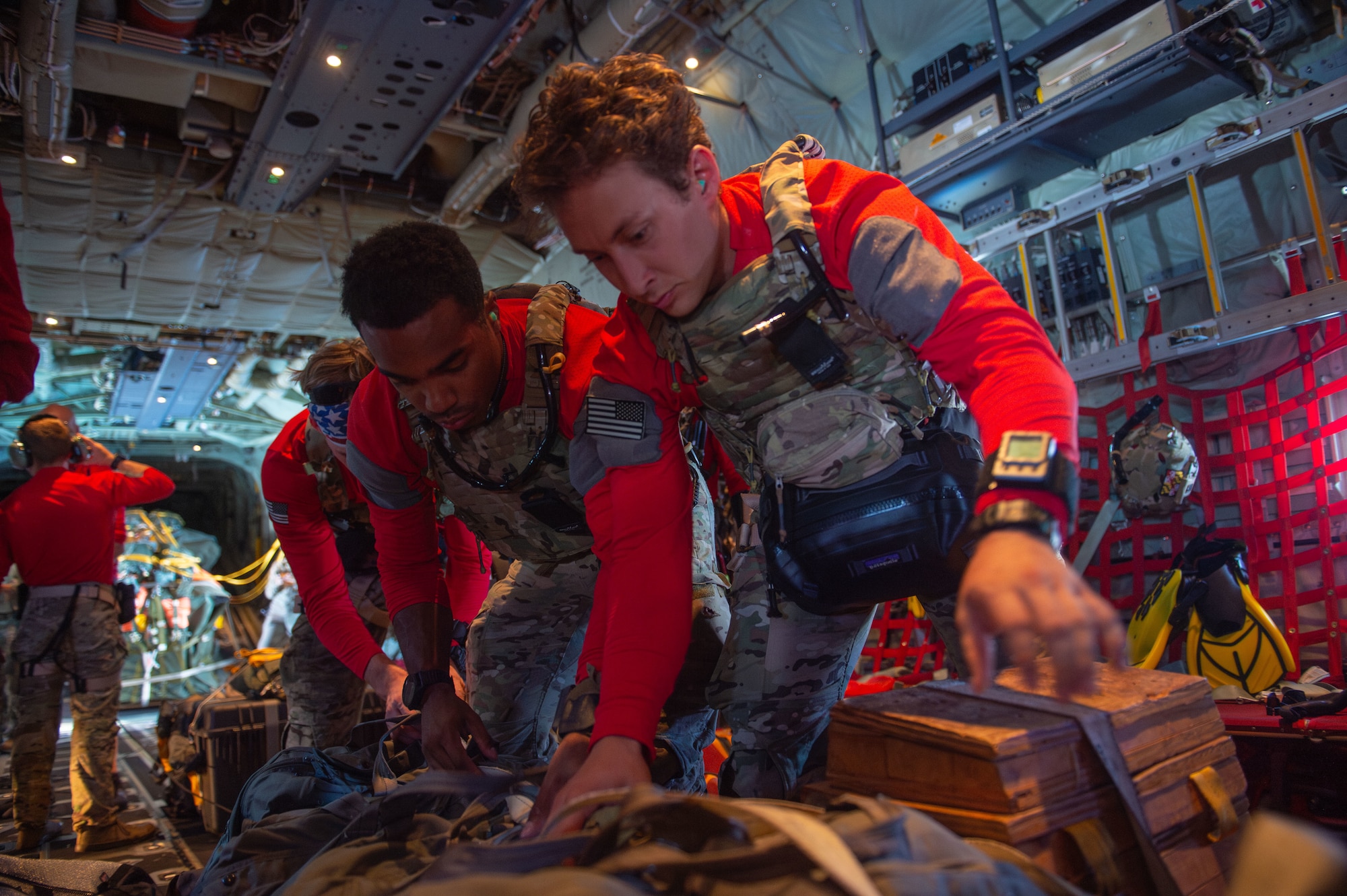 U.S. Air Force Senior Airman Christian Blocker (left) and Staff Sgt. Evan Lau (right), 38th Rescue Squadron pararescue men, collect their parachute bag during a rescue training over the North Atlantic Ocean, July 24, 2024. Rescue squadrons can handle a wide array of rescue scenarios and practicing helps build squadrons interoperability. (U.S. Air Force photo by Airman First Class Sir Wyrick)