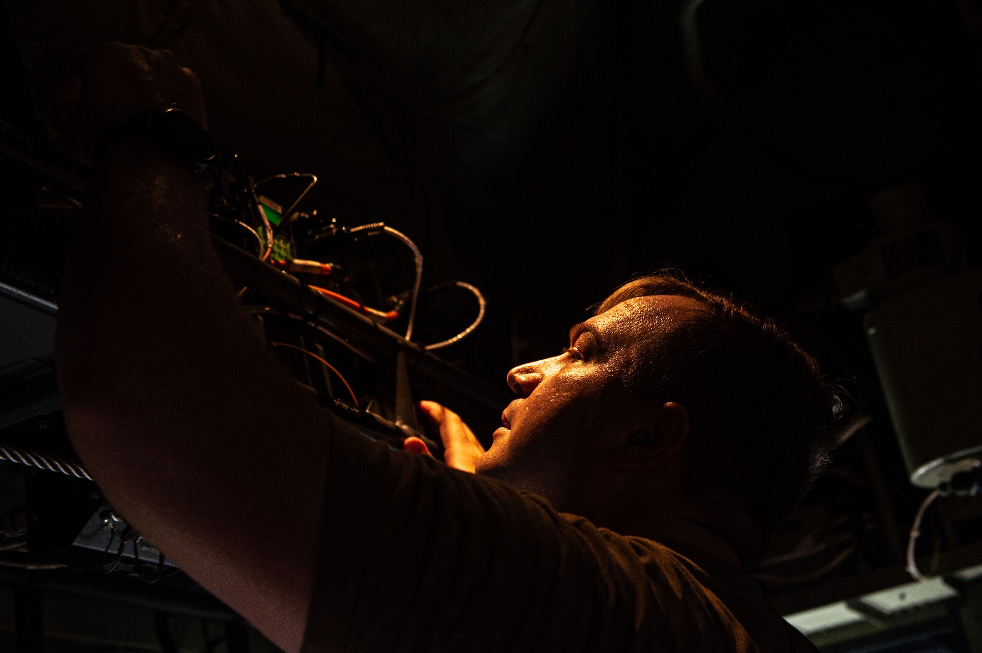 An U.S. Air Force Airman assigned to the 71st Rescue Squadron checks the communication lines on a HC130J Combat King II to prepare for a spin up training at Moody Air Force Base, Georgia, July 24, 2024. The 71st RGS has a wide variety of capabilities that are used as critical assets to execute rescue missions.  (U.S. Air Force photo by Airman First Class Sir Wyrick)
