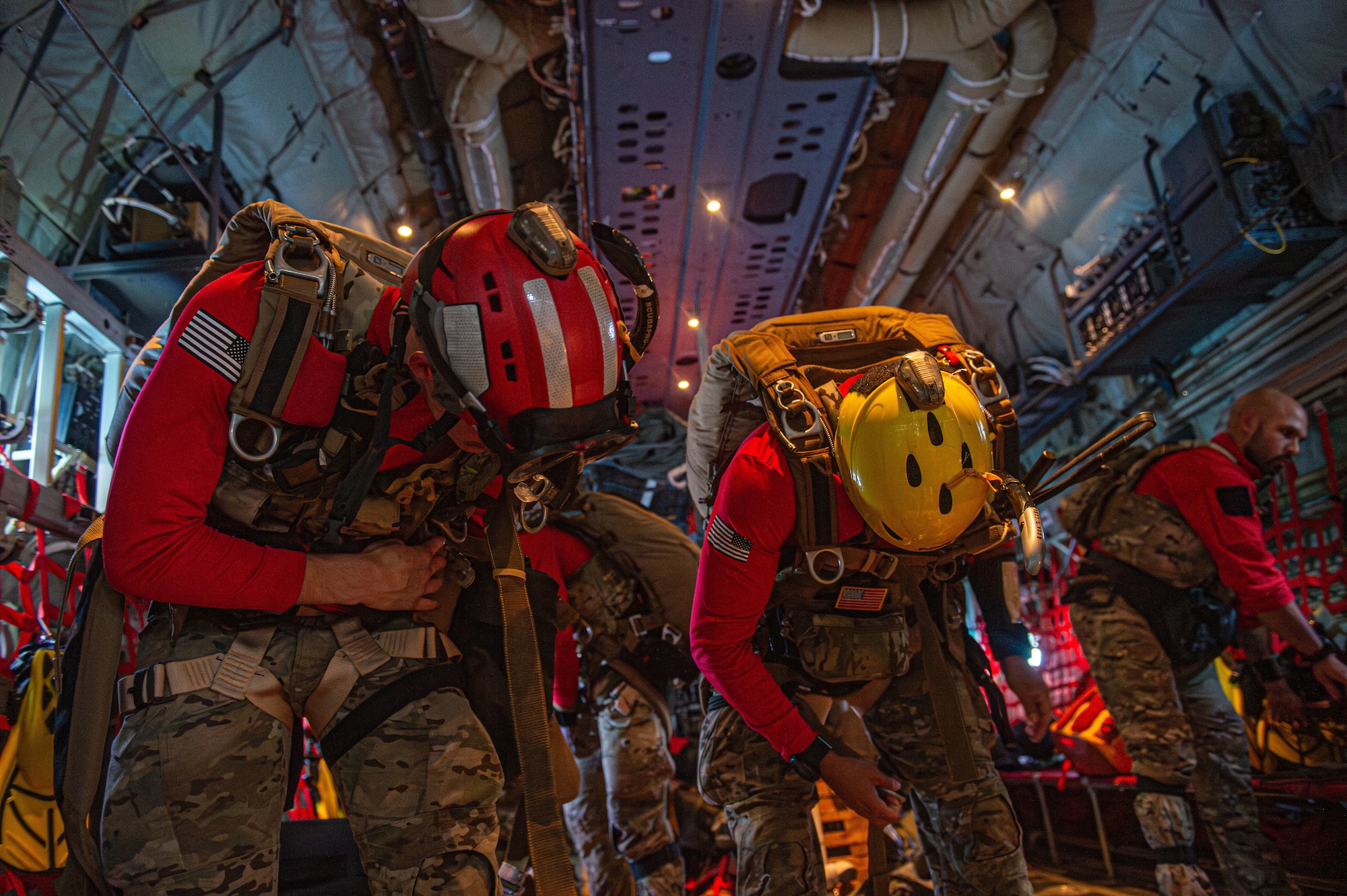 U.S. Air Force Senior Airman Barron Floyd (left) and Tech Sgt. Kaven Jones (right), 93rd Air Ground Operations Wing tactical air control party airman, check to see if they are properly harnessed during rescue training over the North Atlantic Ocean, July 24, 2024. The training was a collaborative effort from the 71st and 38th Rescue Squadrons to prepare for a future deployment. (U.S. Air Force photo by Airman First Class Sir Wyrick)