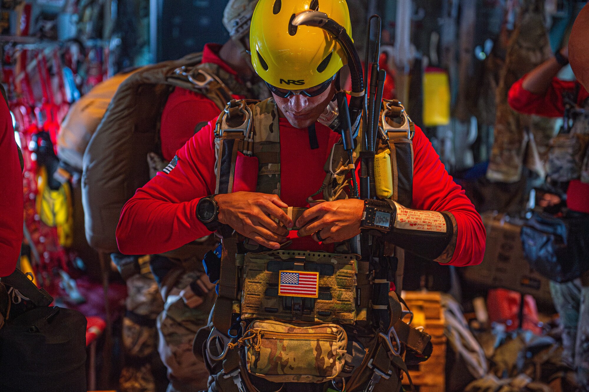 U.S. Air Force Tech Sgt. Kaven Jones, 93rd Air Ground Operations Wing tactical air control party airman, secures his vest during a rescue exercise over the North Atlantic Ocean, July 24, 2024. The training objective was to recover two stranded Airmen that crashed into near the North Atlantic Ocean, building a greater cohesive force for the Moody Air Force Base rescue squadrons.  (U.S. Air Force photo by Airman First Class Sir Wyrick)