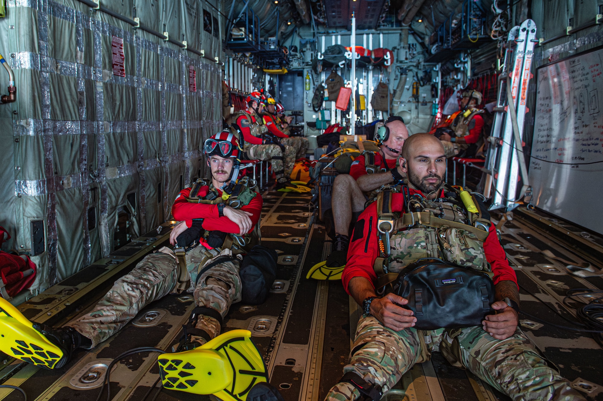 U.S. Air Force Airmen assigned to the 38th Rescue Squadron sit in the back of an HC-130J Combat King II during a spin up training operation over the North Atlantic Ocean, July 24, 2024. This training is two weeks long with different rescue procedures and scenarios being practiced each day in order to prepare Moody Air Force Base rescue squadrons for upcoming deployments. (U.S. Air Force photo by Airman First Class Sir Wyrick)