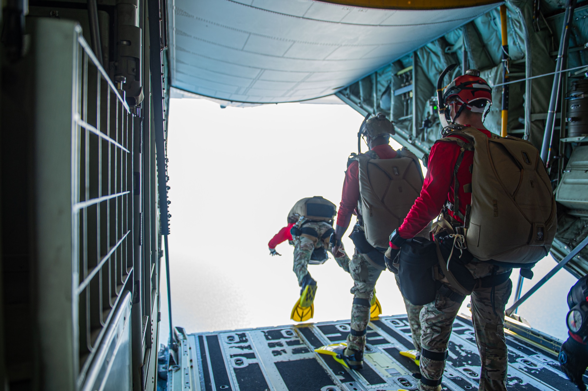 U.S. Air Force Airmen assigned to the 38th Rescue Squadron file in line to jump from a HC130-J Combat King II to execute a pararescue training over the North Atlantic Ocean, July 24, 2024. Rescue squadrons can handle a wide array of rescue scenarios and practicing helps build squadrons interoperability. (U.S. Air Force photo by Airman First Class Sir Wyrick)