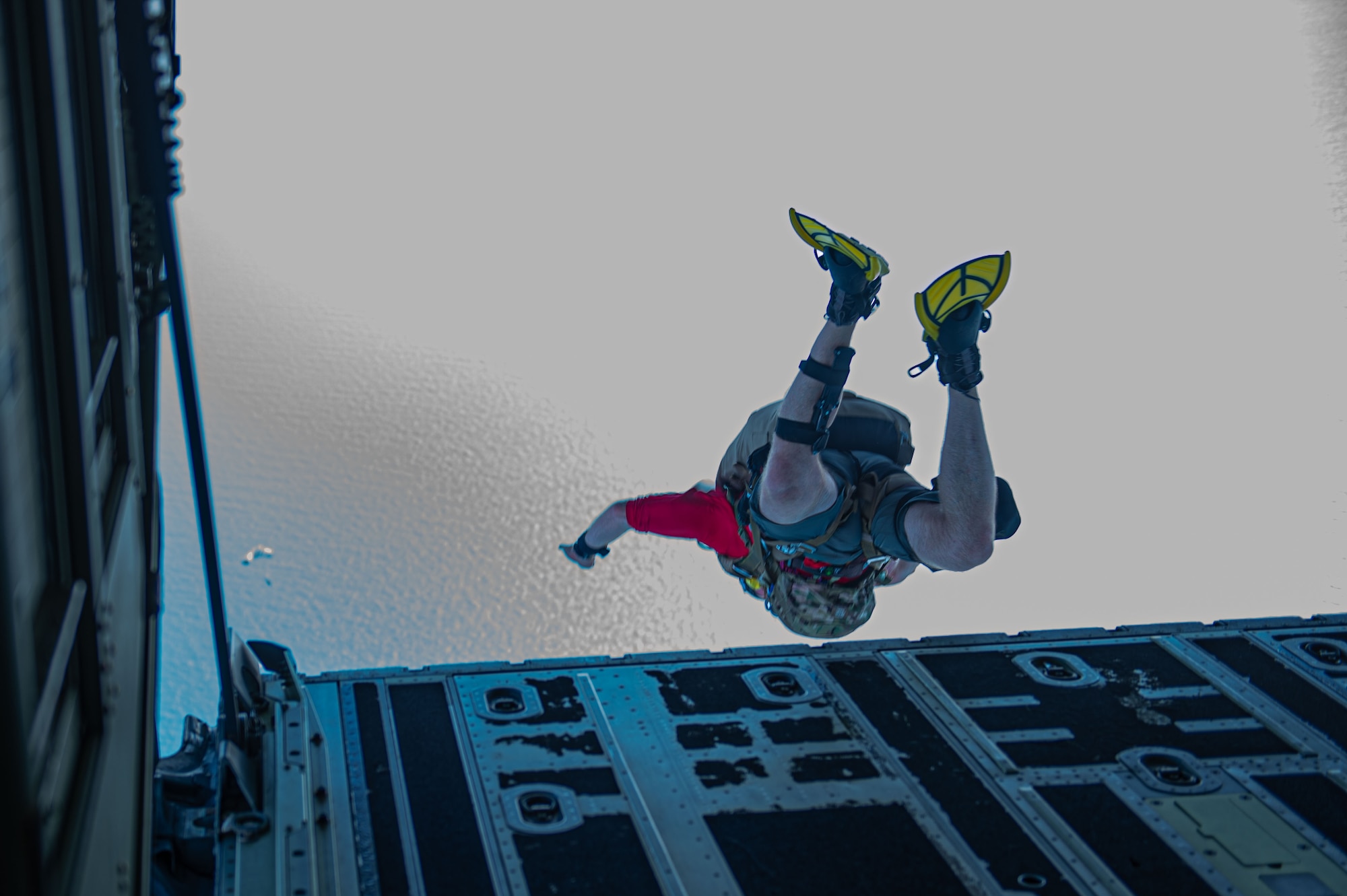 U.S. Air Force Staff Sgt. Bradford Thornburg, 38th Rescue Squadron pararescue specialists (PJ’s), jumps to parachute into the ocean during a rescue training over the North Atlantic Ocean, July 24, 2024. During the training PJ’s and tactical air control party specialists jumped and deployed parachutes in order to rescue stranded Airmen. (U.S. Air Force photo by Airman First Class Sir Wyrick)