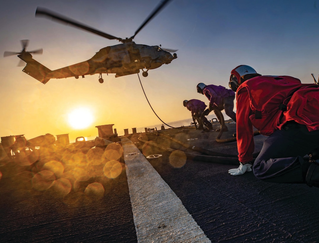 Sailors conduct helicopter in-flight refueling with MH-60R Sea Hawk helicopter assigned to Helicopter Maritime Strike Squadron 79 from flight
deck of guided-missile destroyer USS Carney, operating in Eastern Mediterranean Sea