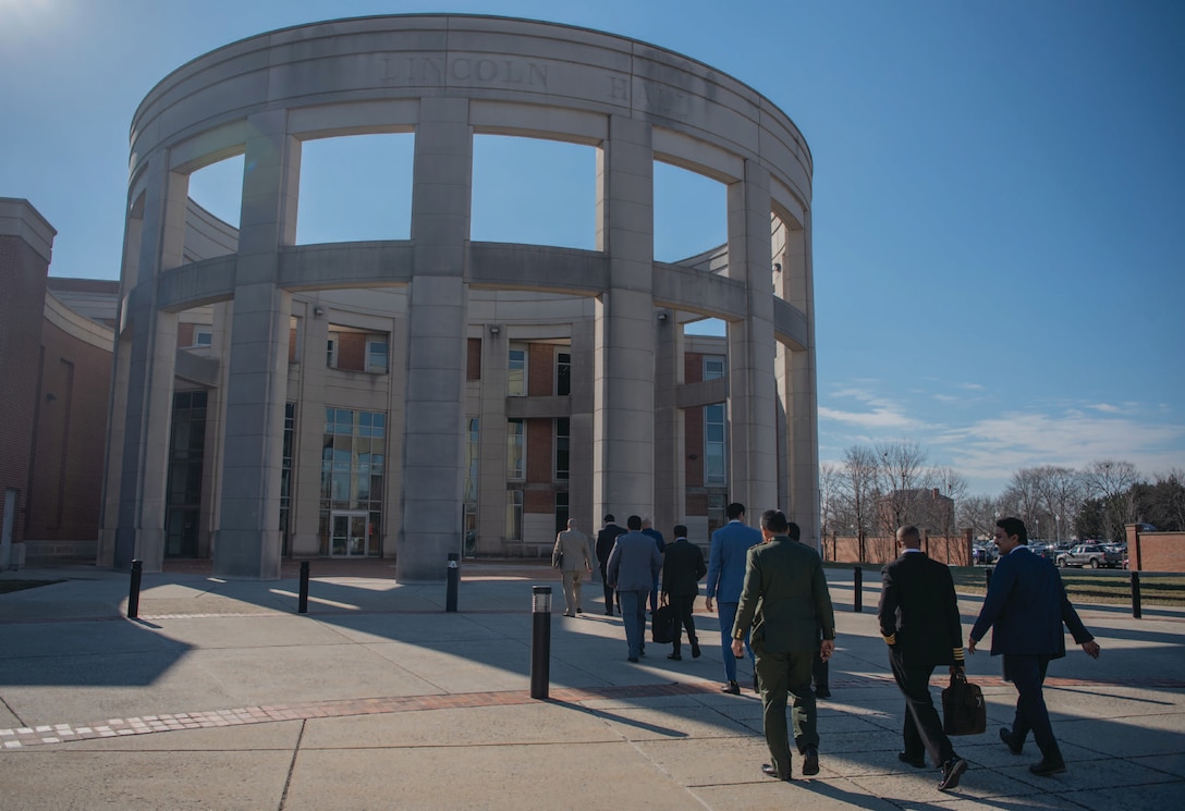 College of International Security Affairs Class of 2023 students walk into Abraham Lincoln Hall, National Defense University.