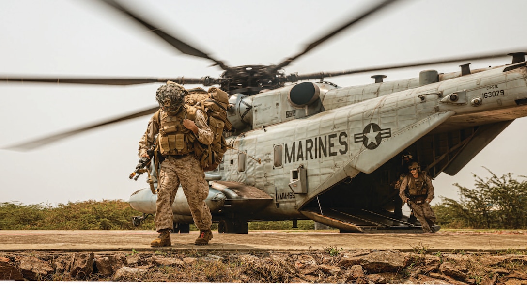 Marines assigned to Charlie Company, Battalion Landing Team 1/5, 15th Marine Expeditionary Unit, exit CH-53E Super Stallion attached to
Marine Medium Tiltrotor Squadron 165 (Reinforced), 15th MEU, for amphibious landing during exercise Tiger Triumph at Kakinada Beach, India.