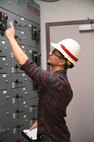 Eric Hedine looking at electrical panels