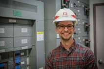 Eric Hedine looking at electrical panels