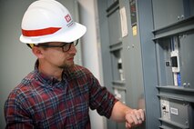 Eric Hedine looking at electrical panels