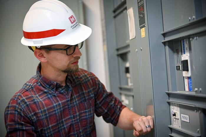 Eric Hedine looking at electrical panels