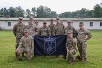 Members of Charlie Company, 3rd Battalion, 172nd Infantry Regiment (Mountain), 54th Troop Command, New Hampshire Army National Guard, pose for a group photo after the closing ceremony of exercise RHINO HEART at the Normandy Barracks in Sennelager, Germany, on June 19, 2024