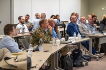 Photo of people listening to a keynote speaker