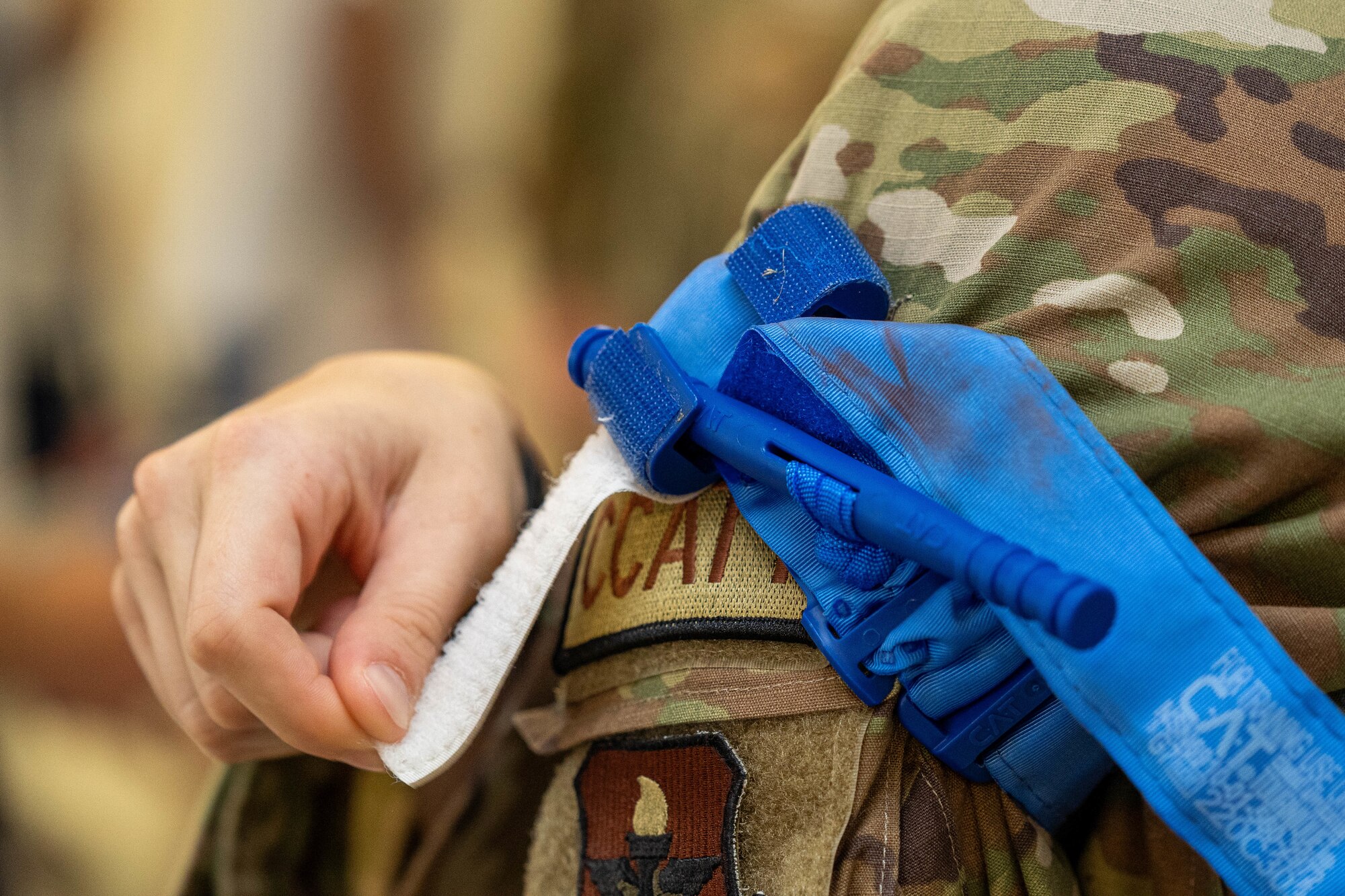 An Airman from the 81st Medical Group demonstrates how to properly secure a tourniquet at the Student Health Fair on Keesler Air Force Base, Mississippi, July 19, 2024.