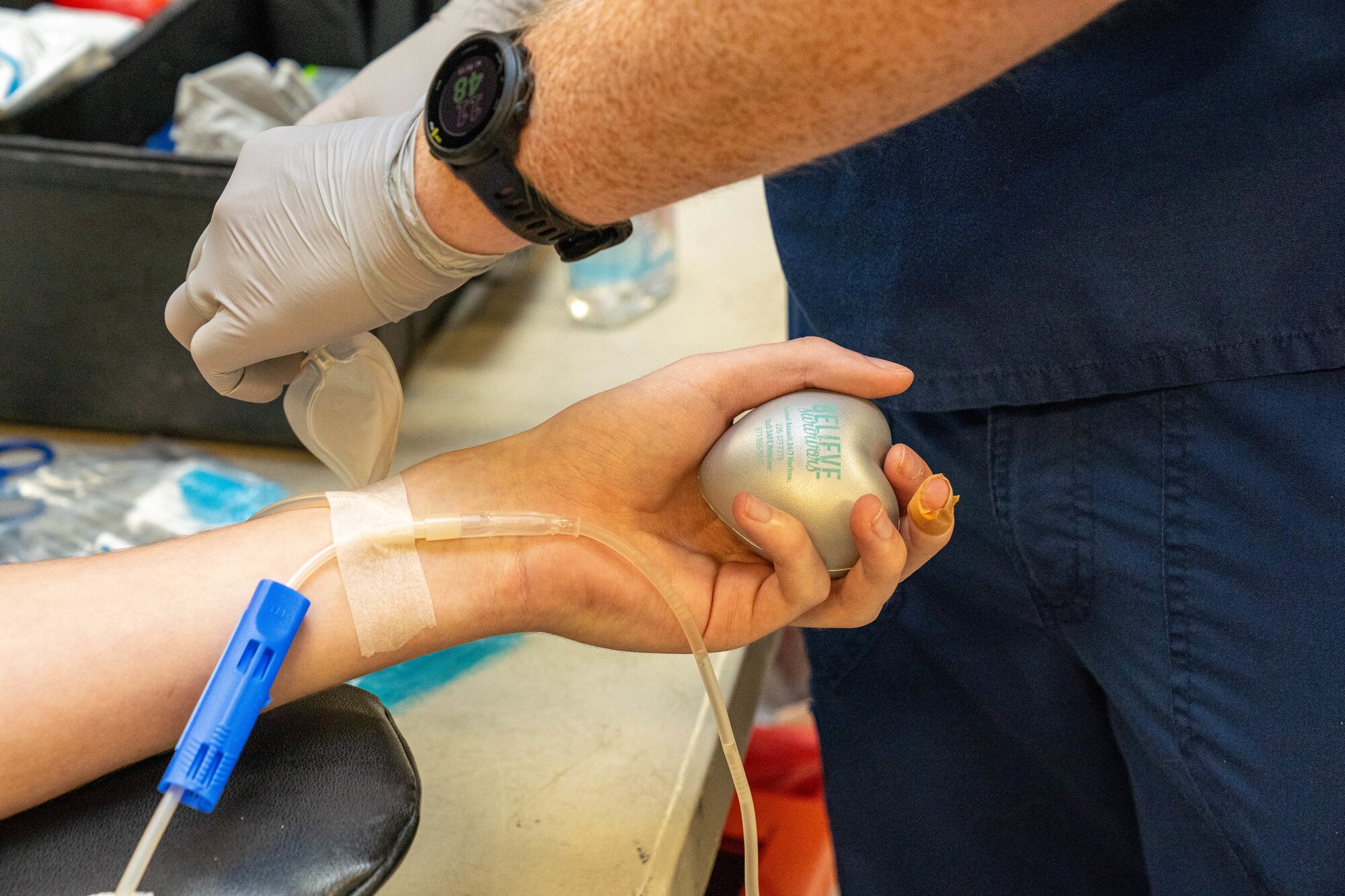 U.S. Air Force Airman 1st Class Tyler Pease, 81st Medical Group aerospace medical technician, squeezes a stress ball while getting his blood drawn at the Student Health Fair on Keesler Air Force Base, Mississippi, July 19, 2024.