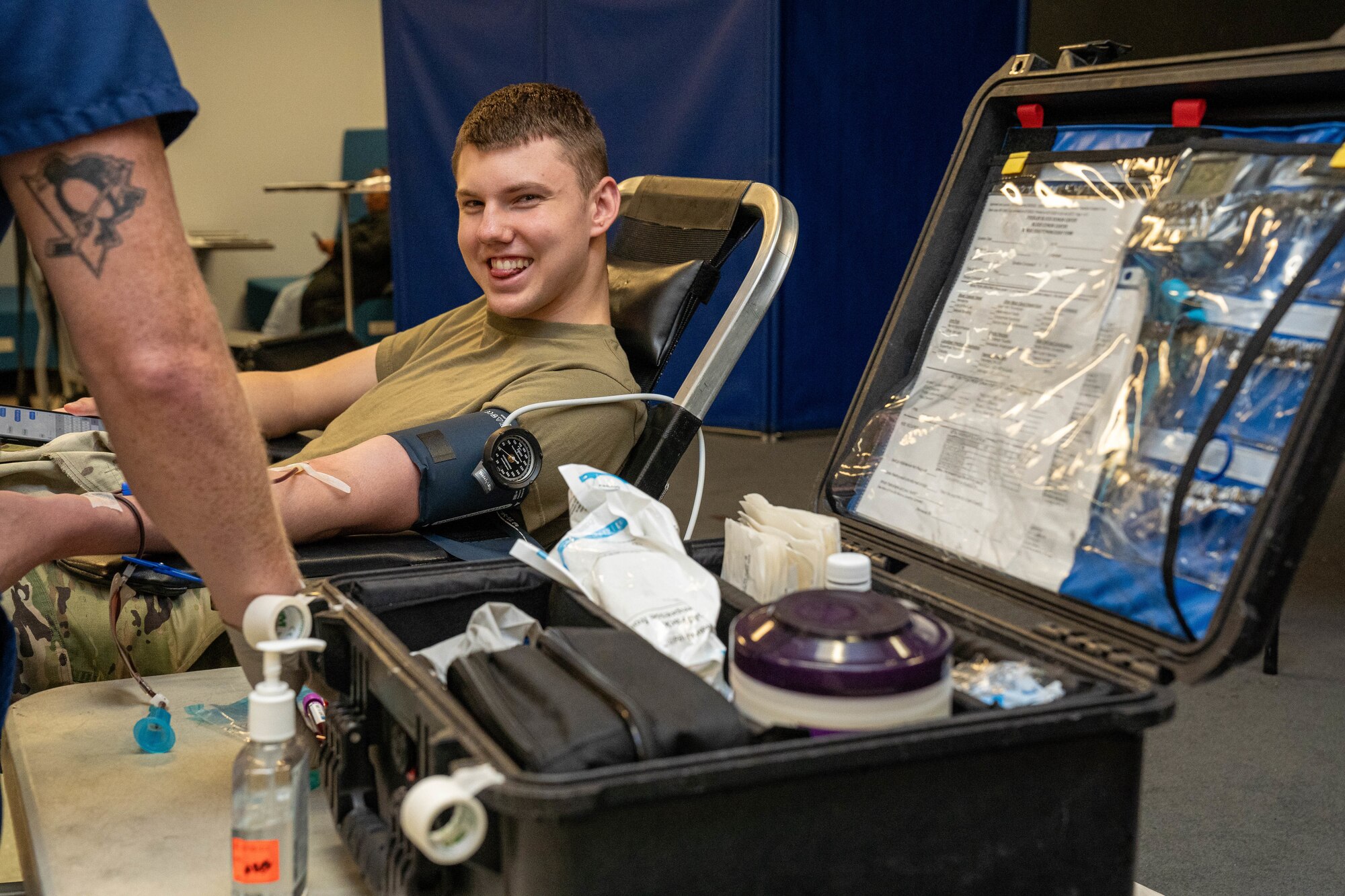 U.S. Air Force Airman 1st Class Tyler Pease, 81st Medical Group aerospace medical technician, smiles while getting his blood drawn at the Student Health Fair on Keesler Air Force Base, Mississippi, July 19, 2024.