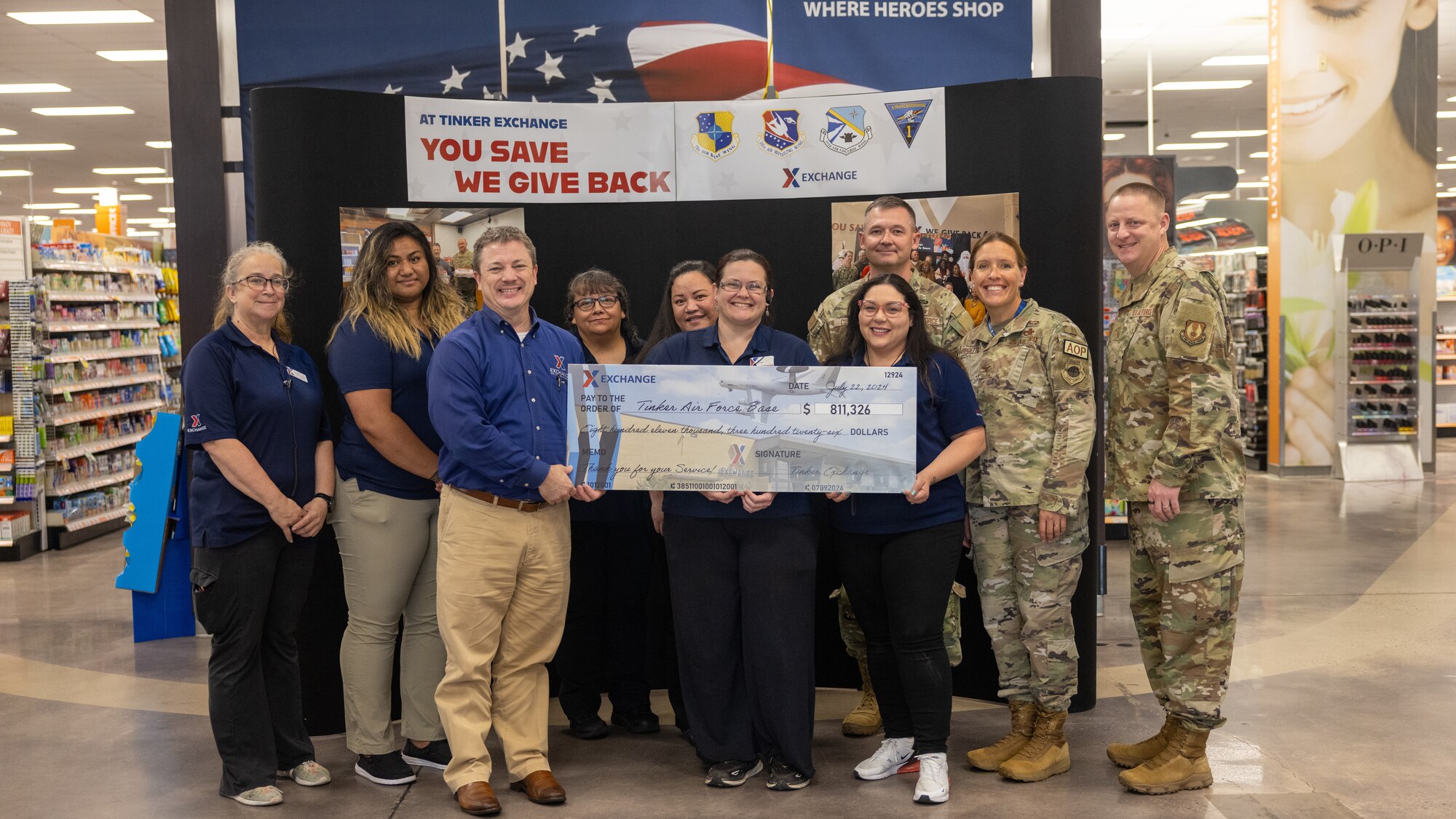 People posing for photo with big check