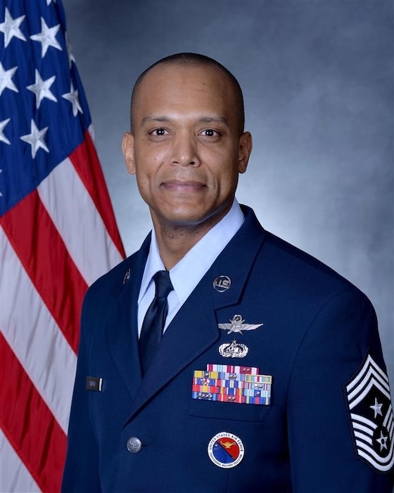 man in uniform poses for picture in studio