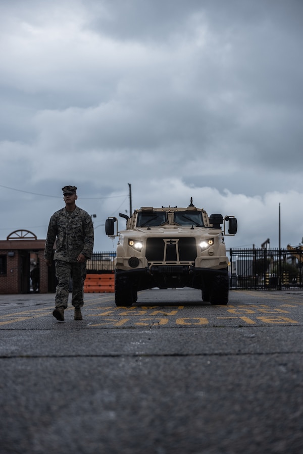 U.S. Marine Corps Lance Cpl. Luis Moncada, a vehicle recovery operator with Combat Logistics Battalion 22, Combat Logistics Regiment 2, 2nd Marine Logistics Group, ground guides a joint light tactical vehicle during Defense Support of Civil Authorities mission rehearsals at Naval Base Norfolk, Virginia, July 22, 2024. Marines and Sailors with the II Marine Expeditionary Force (II MEF) Maritime DSCA Task Force conducted a full mission rehearsal in order to practice deploying as a team in support of civil authorities. This rehearsal was designed by II MEF and United States Fleet Forces Command to integrate and increase amphibious capabilities on the East Coast for potential humanitarian relief and disaster assistance mission during this hurricane season. (U.S. Marine Corps photo by Cpl. Meshaq Hylton)