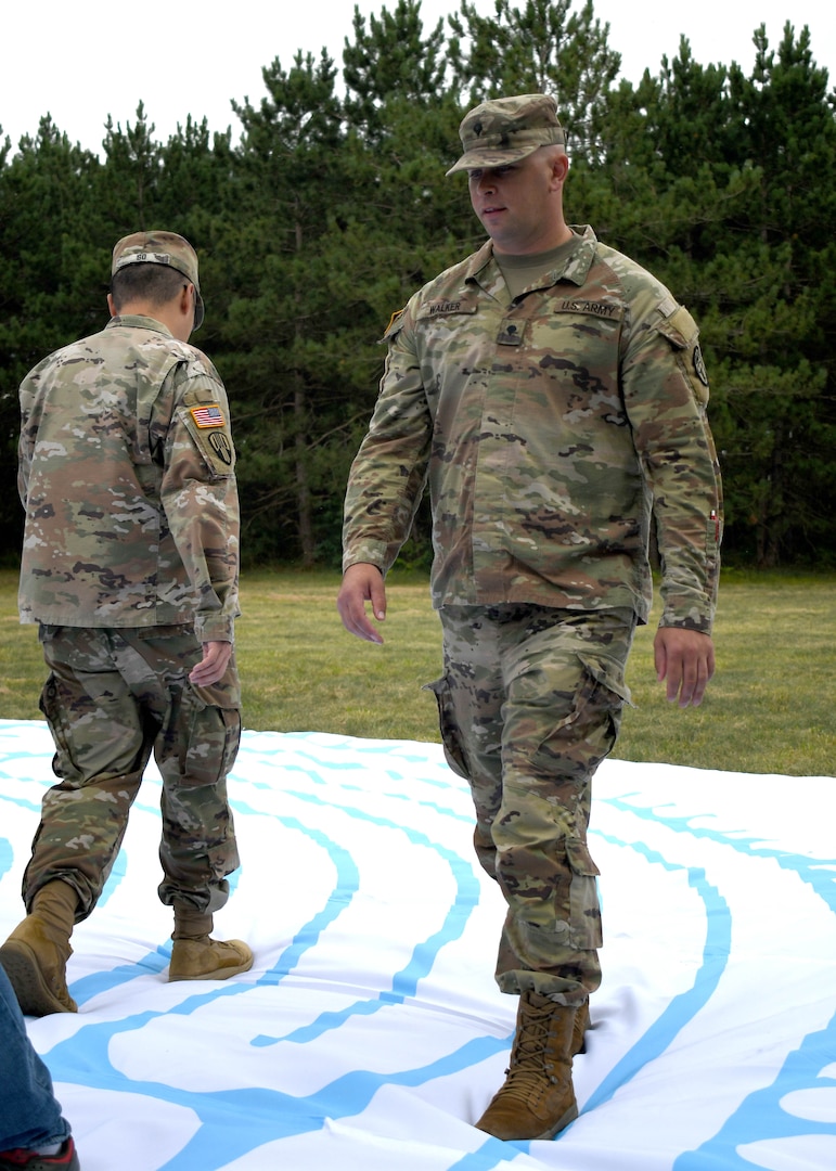 Soldiers in recovery from Fort Drum SRU walk a labyrinth maze.