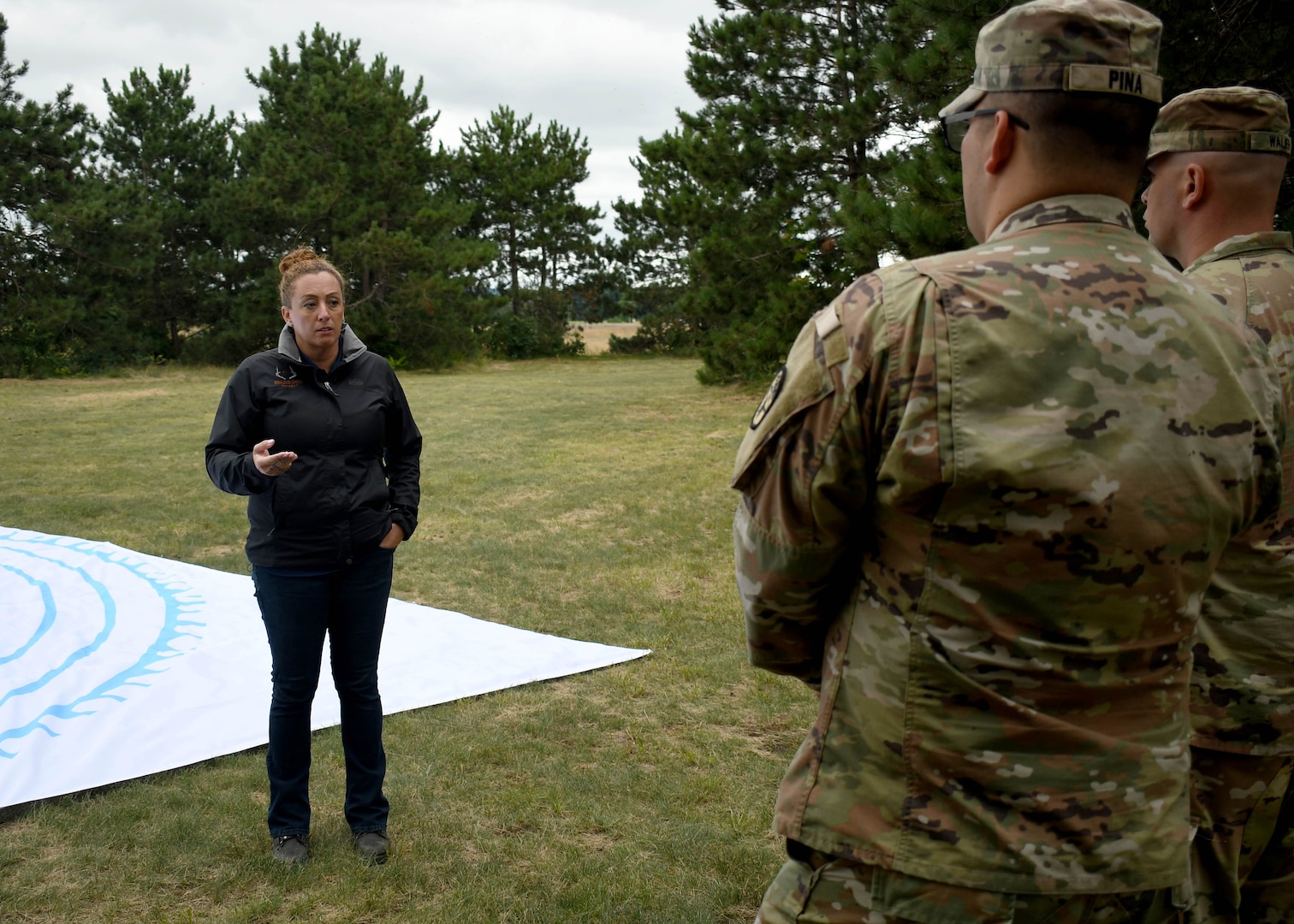 Photo of Boulder Crest program facilitator speaking with Soldiers in front of labyrinth maze.