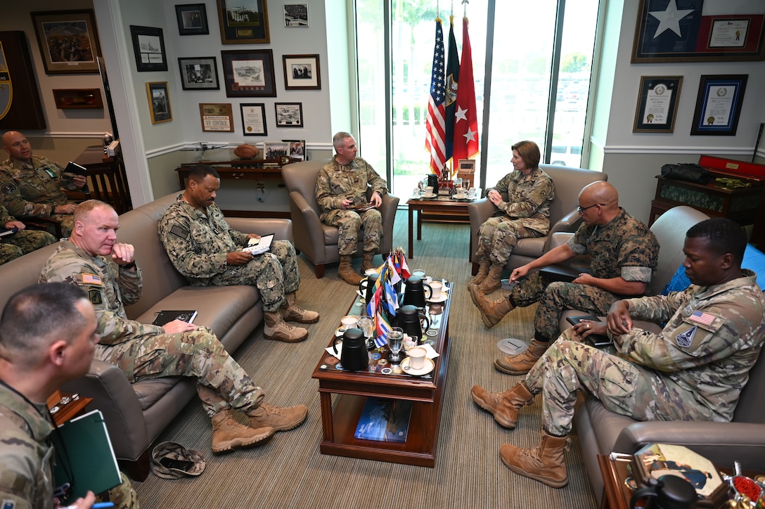 Military officers sit around a table.