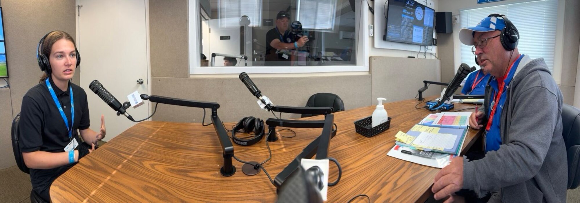 Reagan Hoopes, a software engineer assigned to the 309th Software Engineering Group at Hill Air Force Base, Utah., speaks with local radio hosts Fast Eddy and Digital Dan during their morning radio show Hot Start, inside the EAA radio studio in Oshkosh, Wi., July 26.