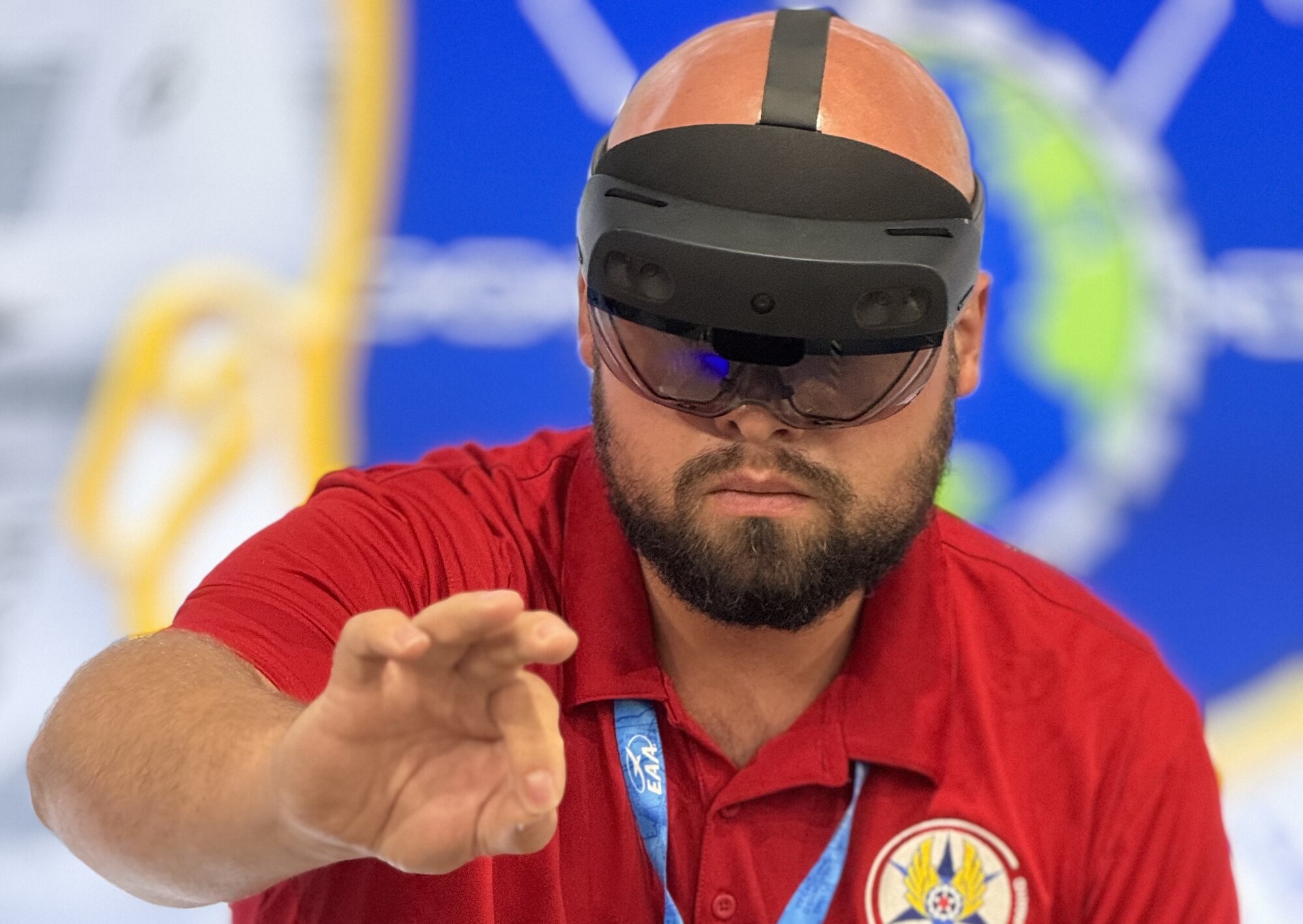 Austin D. Beverley, a project manager from the 309th Software Engineering Group, demonstrates how to use an augmented reality headset during the Experimental Aircraft Association’s AirVenture Oshkosh airshow in Oshkosh, Wi., July 25.