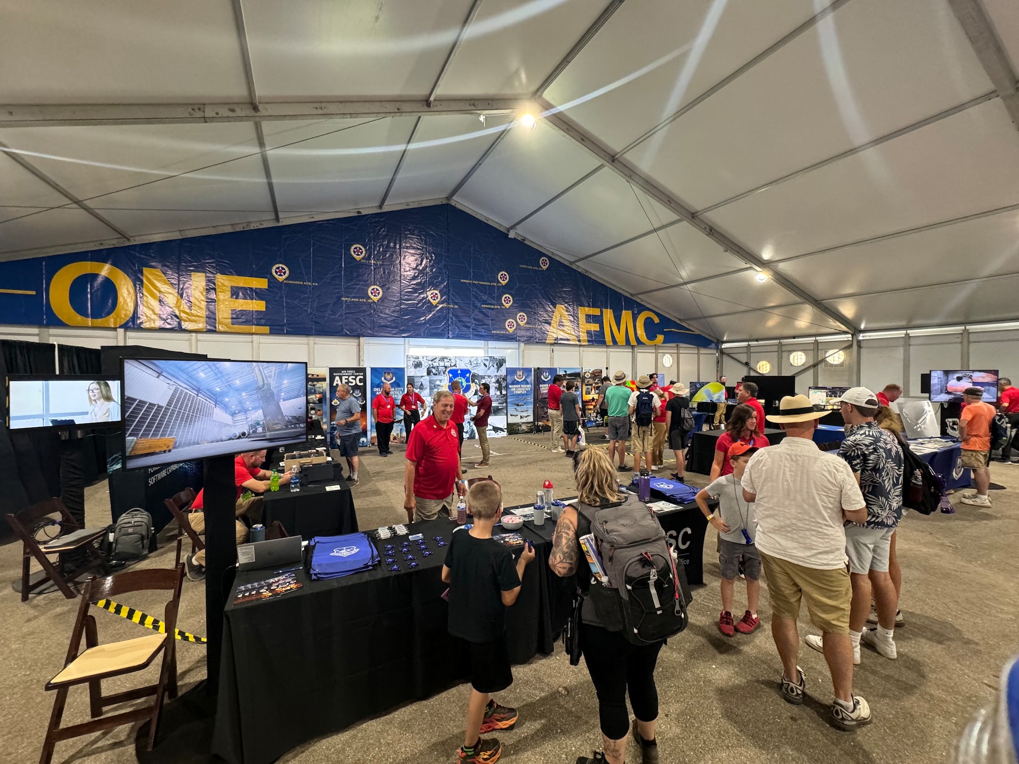 Attendees of the Experimental Aircraft Association’s AirVenture Oshkosh 2024 airshow in Oshkosh, Wi., tour the Air Force Sustainment Center’s exhibit in the Air Force Materiel Command tent on opening day, July 22.