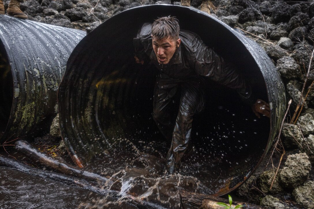 A Naval Reserve Officers Training Corps Midshipman runs through a tunnel while conducting a timed endurance course during Career Orientation and Training for Midshipmen (CORTRAMID) on Camp Lejeune, North Carolina, July 26, 2024. CORTRAMID is a month-long opportunity for Midshipmen to step back from university life and experience the operational communities of the US Navy and Marine Corps. (U.S. Marine Corps photo by Cpl. Mary Kohlmann)